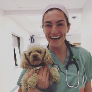 Emily Gregg holding a dog.